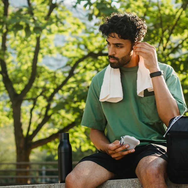 Water bottle and towel on a bench